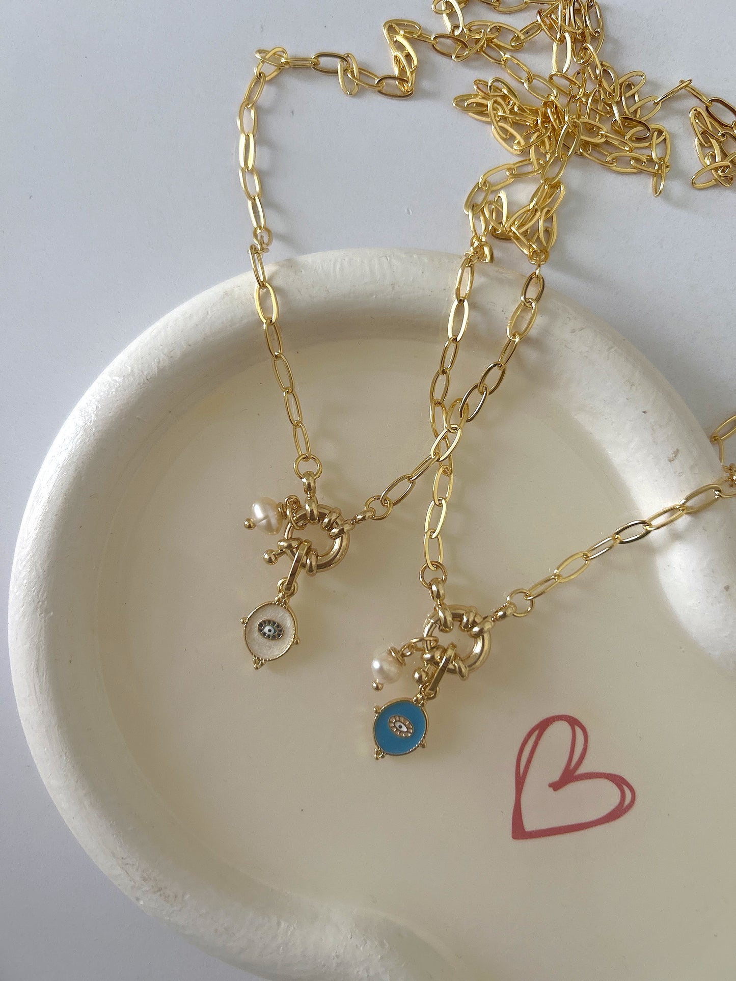 Golden necklace with tiny charm
