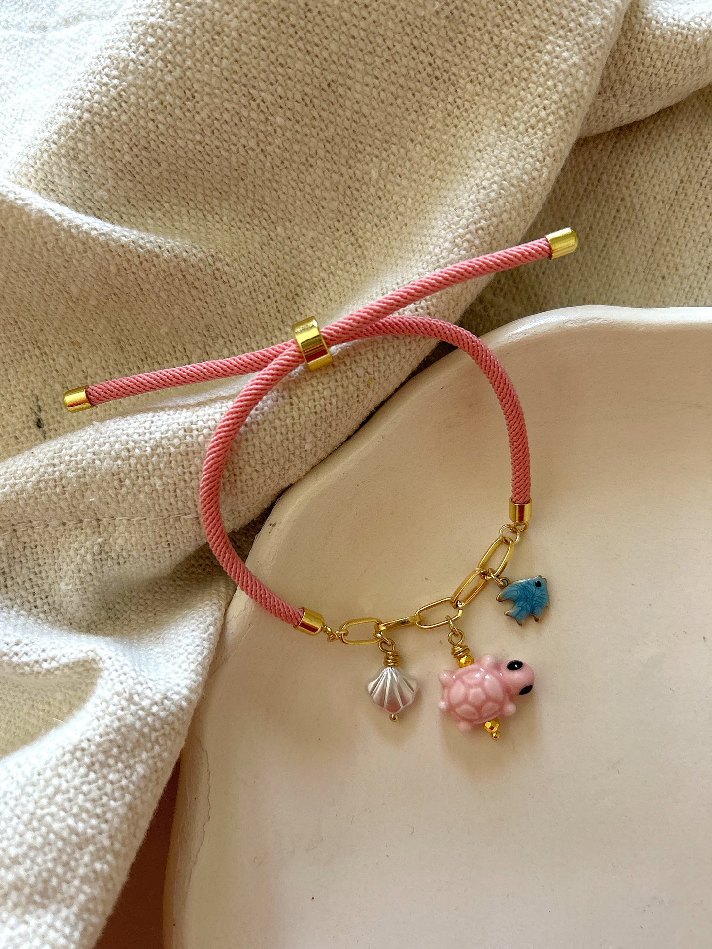 Pink bracelet with turtle charm
