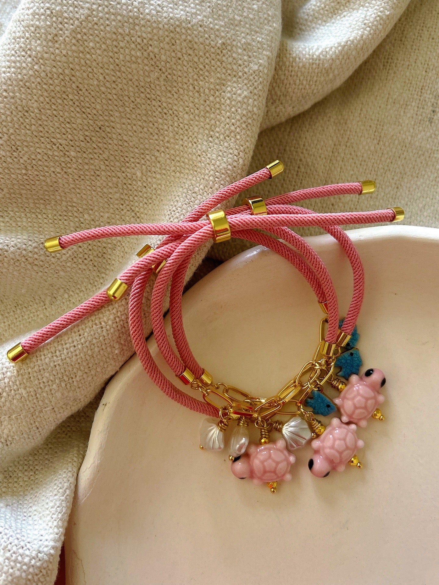 Pink bracelet with turtle charm