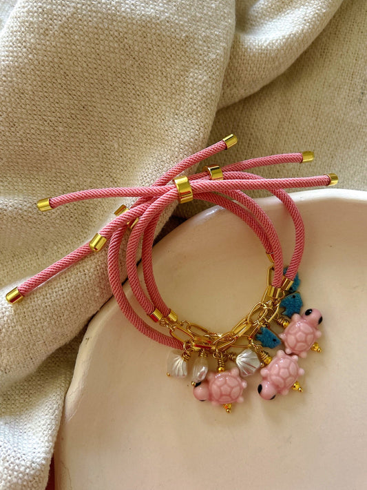 Pink bracelet with turtle charm